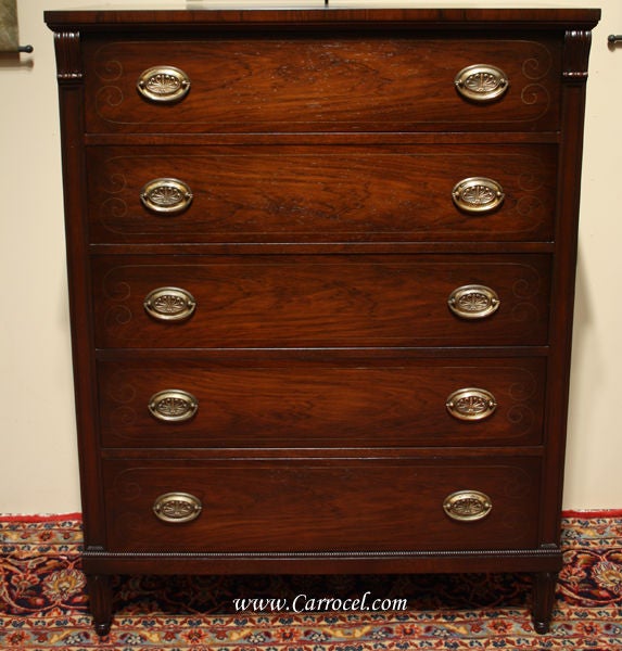 This is a stunning antique highboy made in the 1930s in America.  It features beautiful Honduran mahogany with pin inlay framing each drawer front and solid brass hardware.  It has been undergone a complete restoration process, whereby it has