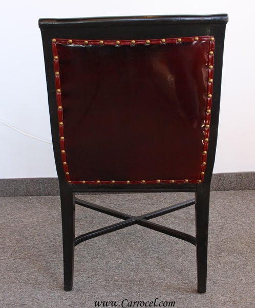 This is a gorgeous chair!  It has been finished in a nice ebony with hand-painted gold highlighting on the carvings.  It is in its original excellent condition except for the upholstery, which we did in a beautiful rich burgundy leather finished off