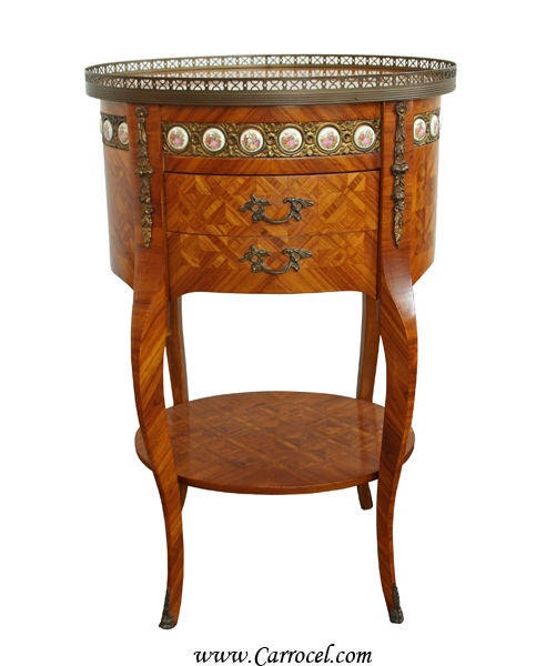 This listing is for a gorgeous circa 1940s tulip wood end table.  It has parquet tulip wood veneers with solid brass carved accents and a lovely brass edge surrounding the top.  Featuring hand-painted porcelain ormolu and classic English dovetail