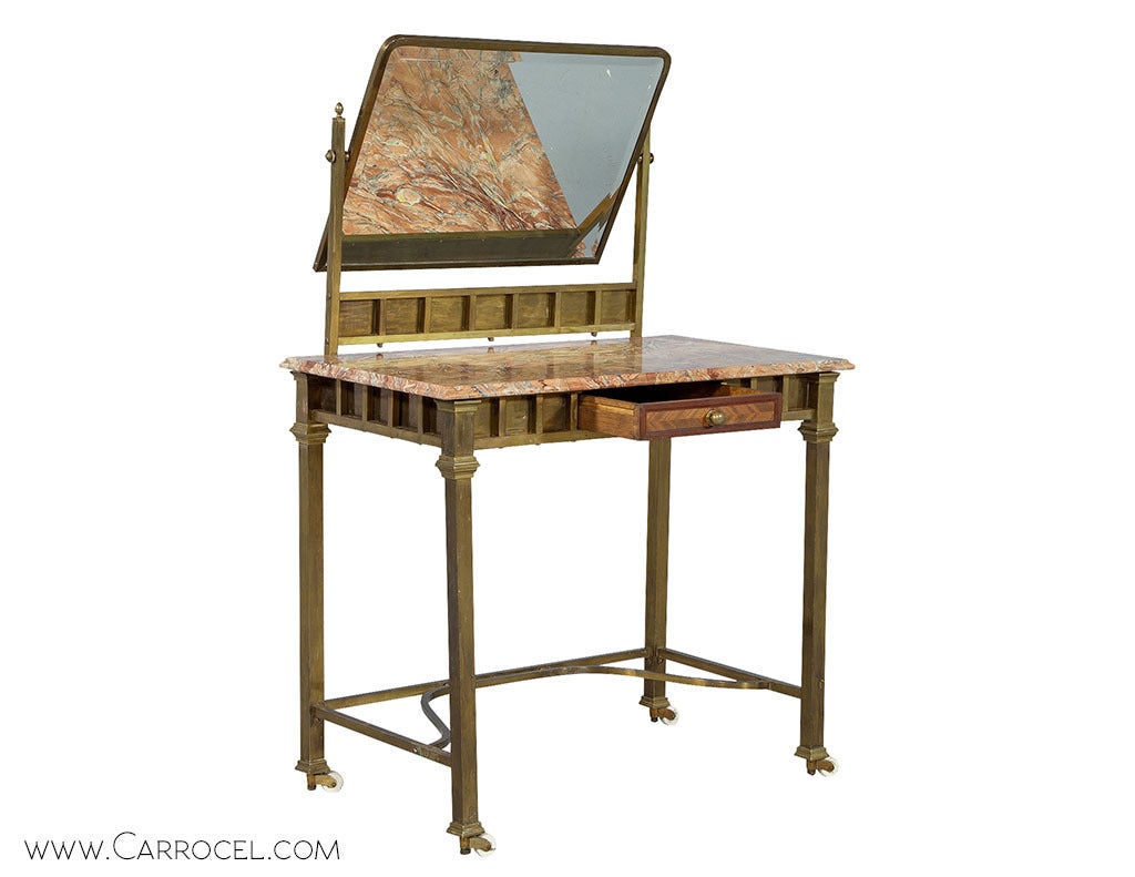 If you're on the lookout for some retro redecorating ideas, this vintage French Modernist vanity makeup table could be just the thing for you. Uniquely designed in brass, with an original marble top, brass framed mirror and fretted accents, this