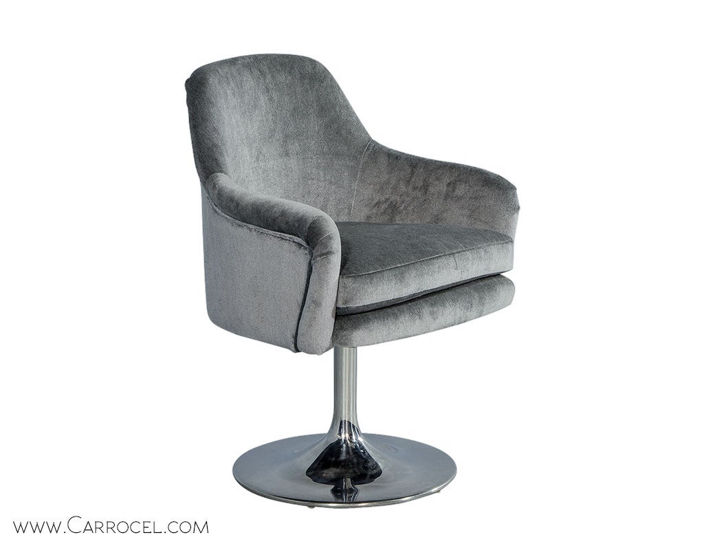 Featuring the vintage combination of metal frame and fabric seen in most Mid Century models, these swivel chairs are suited for use in a study or as accent pieces in a living room. The original chrome finished steel frames have been newly