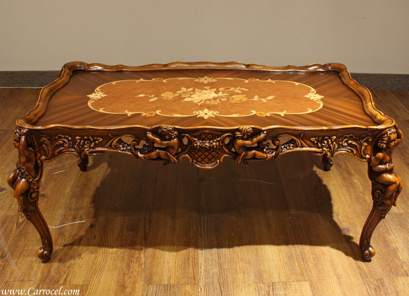 Here we have available a stunning coffee table and living room set.  Made in the 1920s in America, this completely restored hand-carved 3 piece set has spectacularly detailed and ornate carvings.  It also features gorgeous floral inlay atop