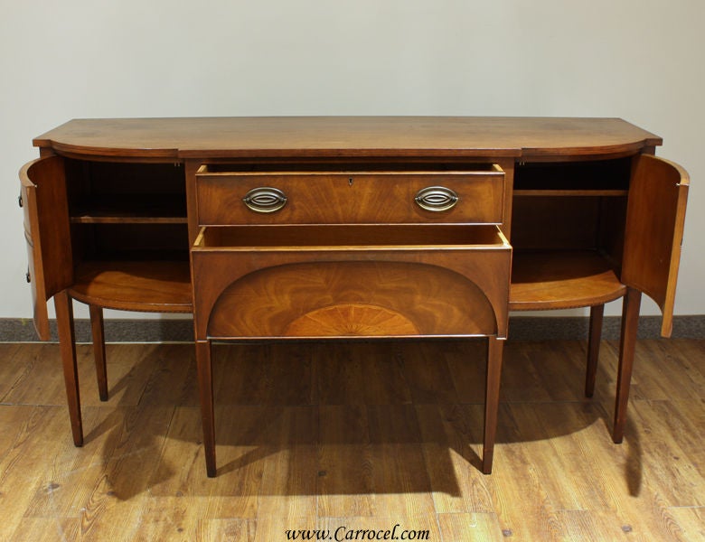 This beautiful mahogany sideboard was made in the early 20th century in the Northeastern United States.  Throughout its life, it has developed a rich patina that only time and careful care can yield.  The mahogany is gorgeous to look at from all