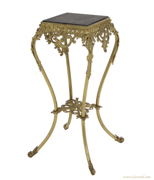 This antique solid brass carved hall stand was made in America - circa 1930s.  It features ornately carved detailing and is in excellent original condition.  The dark marble top is also original and has no major scratches or marks.  This piece is a