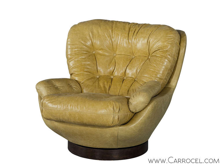 Vintage swivel glove chair reupholstered in a distressed Italian designer leather with a wood base, circa 1960.
