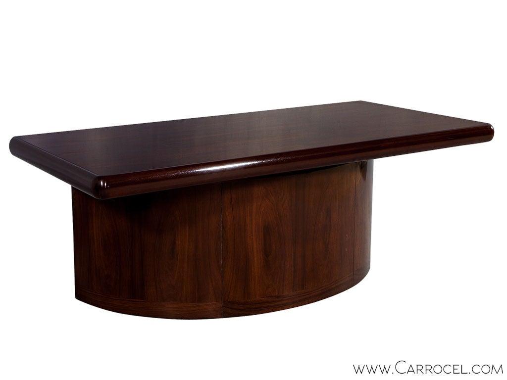 Flaunt this stylish Mid Century desk from the Carrocel Revival collection in your study. A rosewood body with a demilune base and rectangular top, with three slim drawers on the front, exudes a polished elegance thanks to weighty proportions,
