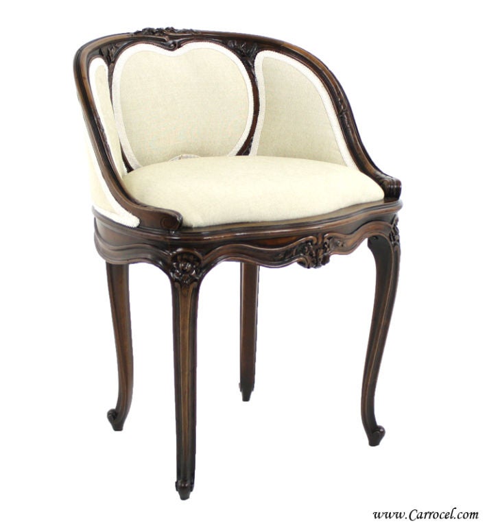 This antique small chair has been restored by our skilled artisans.  Finished to its original dark walnut and upholstered with a clean beige cream fabric, it features gorgeous gimp and delicate floral carvings.  It is a perfect accent piece for your