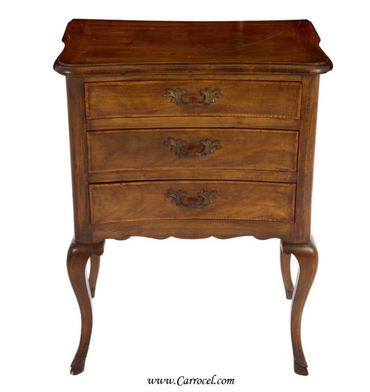 This pair of French Country styled end tables are made from walnut and are American.  Made in the early to mid 20th century, they feature solid English dovetail joinery for maximum tensile strength, solid walnut construction, and lovely contrasting