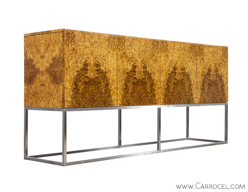 A stunning book-matched golden madrona veneer characterizes and defines the beauty of the linear and clean-lined buffet. With Mid Century roots this buffet is a modern version of Milo Baughman’s classic design. The interior is concealed by four