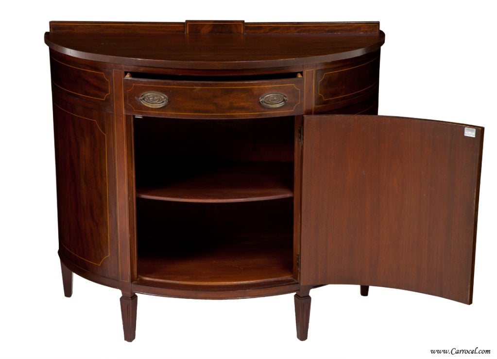 Here we have a federal style piece made in Buffalo, NY in the 1920s by Henry C Steul & Sons Furniture.  A small establishment, they manufactured quality furniture with care and precision attention to details and materials.  We see that this demi