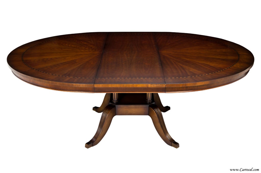 This stunning dining table is newly made in North Carolina and imported to our shop where it was custom finished in a rich medium brown with a hand-rubbed finish.  It features a beautifully figured cherry wood top with diamond patterned banding. 