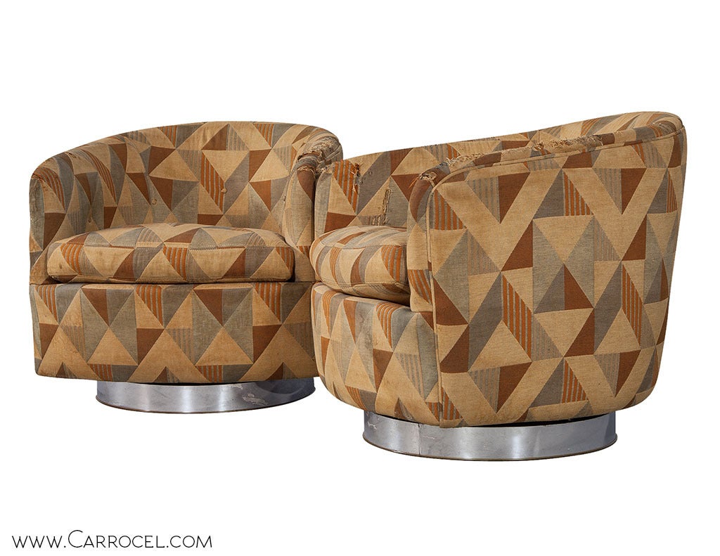 A pair of original Milo Baughman swivel chairs, all set to fill your home with some vintage Mid Century Modern sophistication. Each barrel backed, fully upholstered wooden armchair rests on a brushed nickel pedestal and bears the designer’s seal of