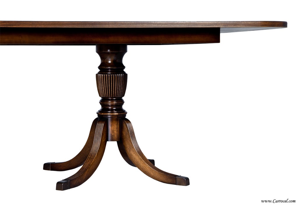 This is a gorgeous dining table made in North Carolina and custom finished by us at Carrocel Restorations.  Made with beautifully figured cathedral mahogany coupled with carefully selected satinwood banding, it is large enough to accommodate all of