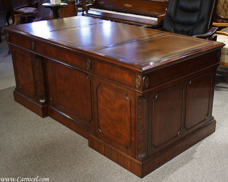 This is a beautiful executive fit for a president! Made in North Carolina, this absolutely gorgeous desk has three leather top sections with carefully-placed gold tooling around the edges. It features 7 pull-out drawers with solid oak construction