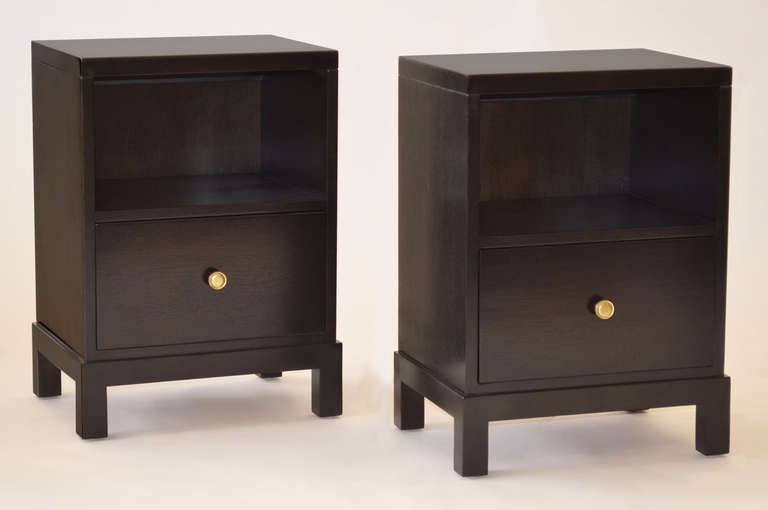 Pair of one-drawer nightstands by T.H. Robsjohn Gibbings for Widdicomb Furniture in ebonized mahogany finish with brass pulls. 
Labeled 