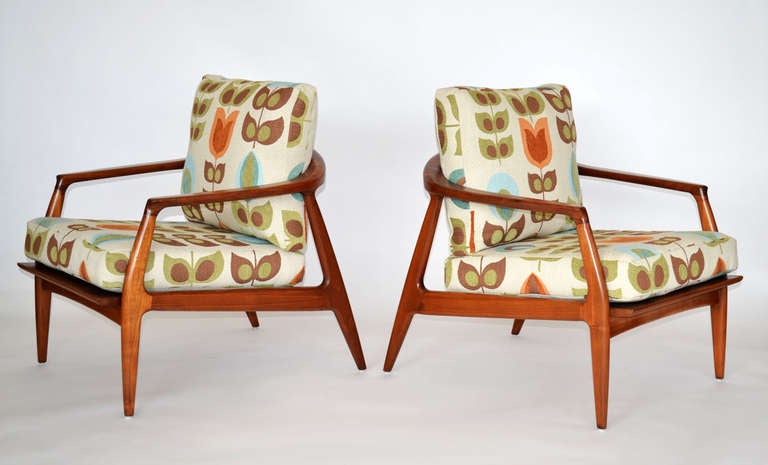Delightful pair of Danish modern lounge chairs with delicate curved arms, wrap boldly around to form the back joined to an organic sculpted frame.  Loose seat and back cushions, recently upholstered in complimentary quilted fabric.