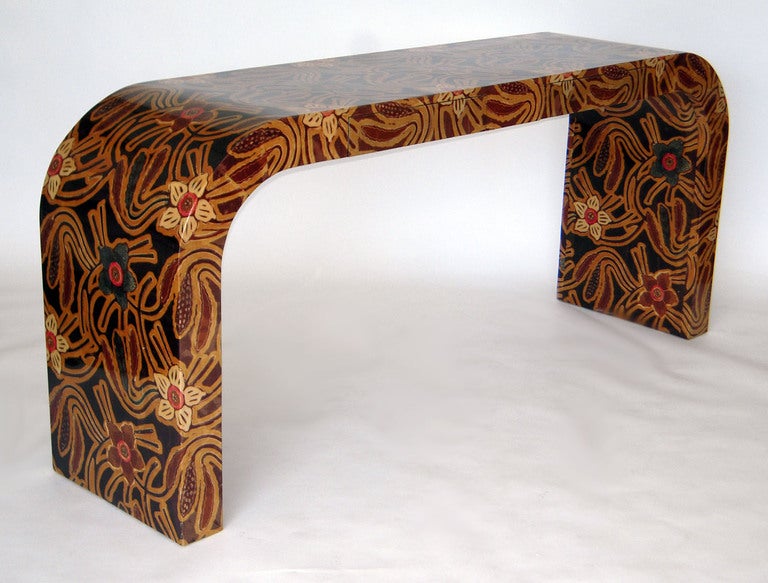 Waterfall form with two drawers, fully finished in dyed parchment or Batik in African floral design with gloss epoxy finish.