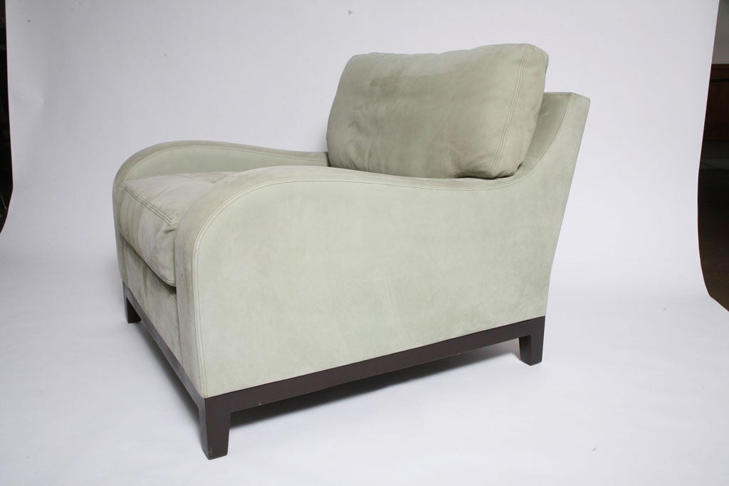 Superb set of matching lounge chairs, with down filled cushions, upholstered in a silver hue green suede, with rich brown framing and legs. Labeled.<br />
<br />
Category: Club Chairs, Arm Chairs, Living Room Chairs