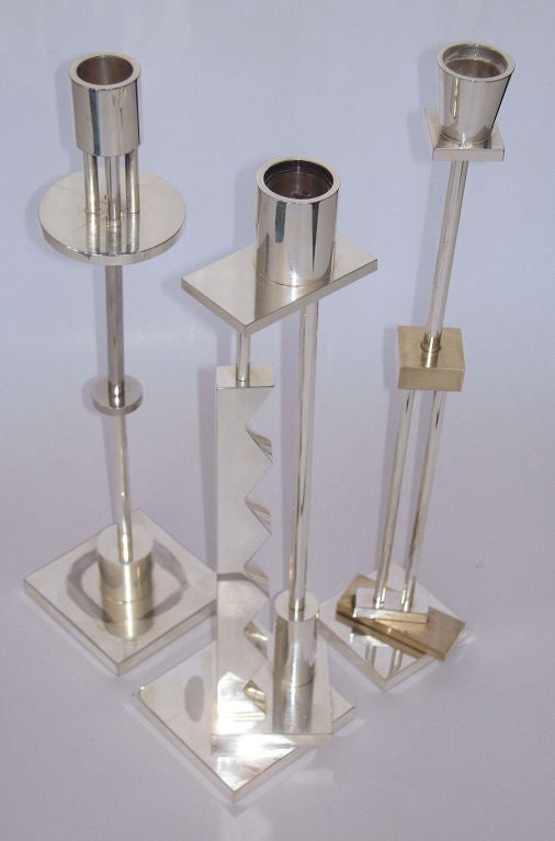 Set of three Memphis-inspired postmodern design silver plated geometric design candlesticks designed by Italian impresario Ettore Sottsass for Swid Powell. Each fully marked and impressed with Sottsass signature, Swid Powell stamp, 