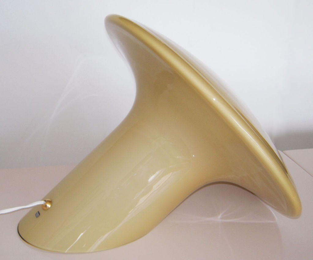 Sculptural Vistosi 'Candia' Italian cased glass table lamp. Mushroom-shaped, resting on one side. Perfect for any vertical surface. Pale gold in color. Near opaque light source, 1970s, Italy.
