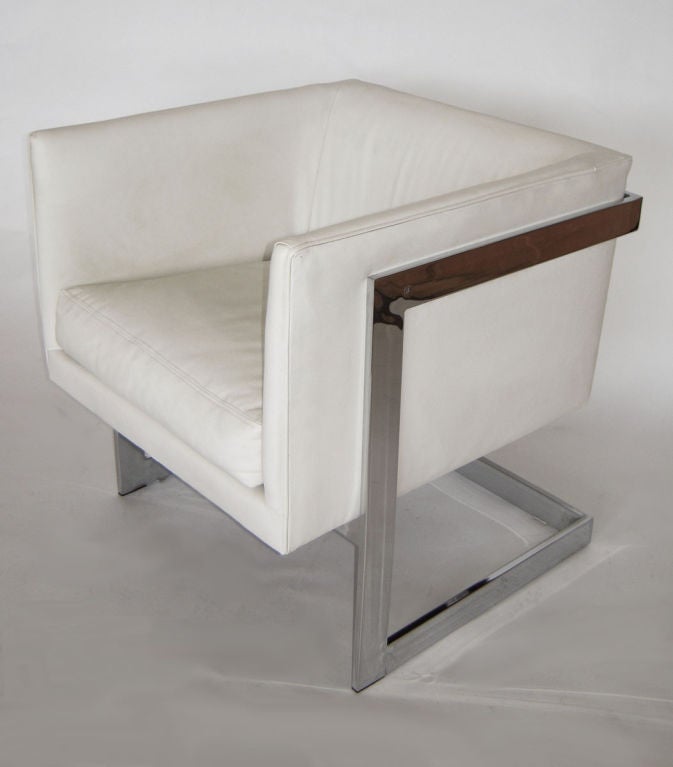 Super sleek lounge chair designed by Milo Baughman for Thayer Coggin. Cube frame is upholstered in white leather, floats inside a mirrored flat steel open frame base. Labeled.