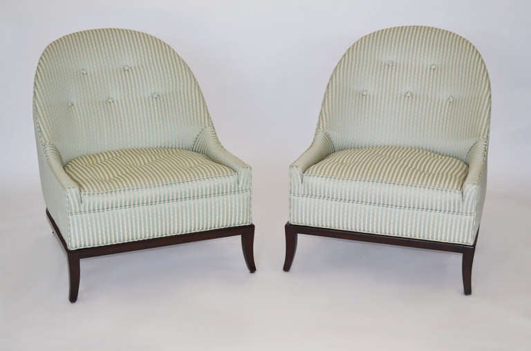 Beautiful pair of model 2043 slipper lounge chairs in dark walnut and newer striped silk buttoned upholstery by T. H. Robsjohn-Gibbings for Widdicomb.