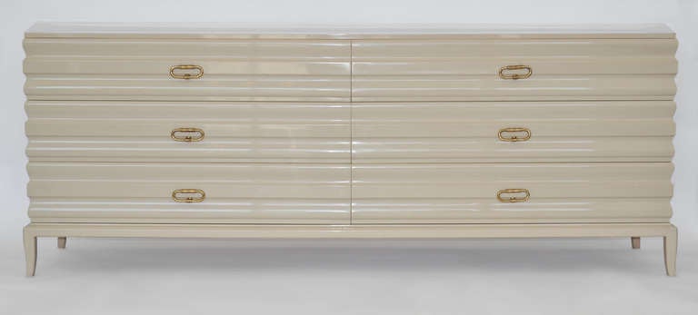 Large sculptural design lacquered wood dresser cabinet on legs with six drawers, original finish in oatmeal with exquisite etched brass drop pulls. Price Includes shipping costs in the cont. U.S., please contact us with your zip code for details. 