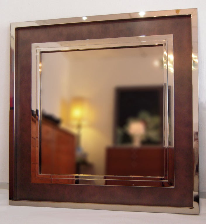 Monumental Steel and Copper Wall Mirror by Maison Jansen 1980's. A superb decorative bronze tone mirror with a triple band polished stainless steel frame and mottled copper matting and bronze mirror.