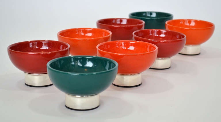 Delightfully colorful set of eight Bauhaus-inspired dessert or sherbert bowls of ceramic cups over German silver plate footing. Three orange, three red and two green bowls.

Complimentary shipping in the Cont. U.S.