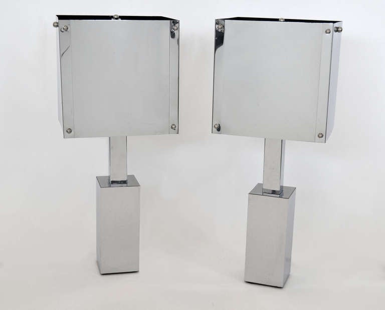 Minimalist, machine-age modern constructed chrome table lamps with chrome shades. Chrome plated bent steel on base and shades.
