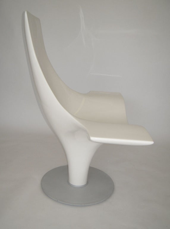 Sculptural lounge chair constructed of reinforced fiberglass body on a heavy powder-coated metal base. 