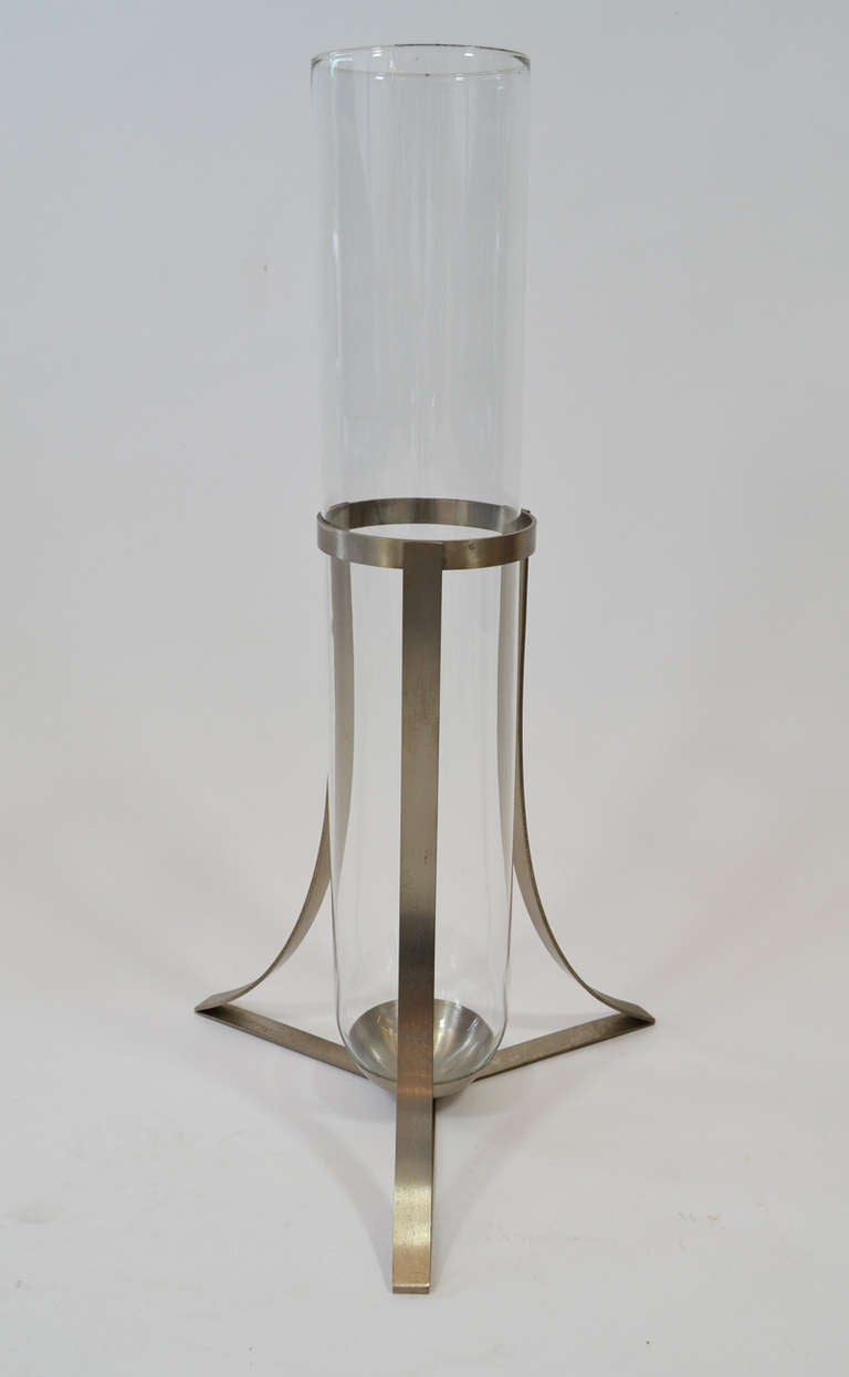 Tall tubular glass vase inside brushed nickel pedestal. Signed.