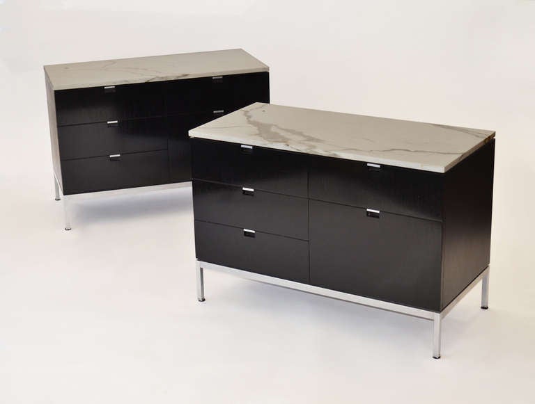 Pair of Executive Group locking cabinets in ebonized walnut with white cremo marble tops on chrome legs.