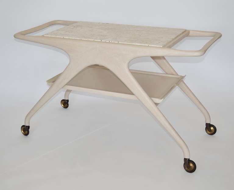 A rare Vladimir Kagan sculpted wood tea/cocktail trolley (VK 430) custom ordered in whitewash walnut with a travertine top and removable wood and laminate tray. Signed. An early Kagan design, hand-made in the Kagan workshop in the 1960's, in