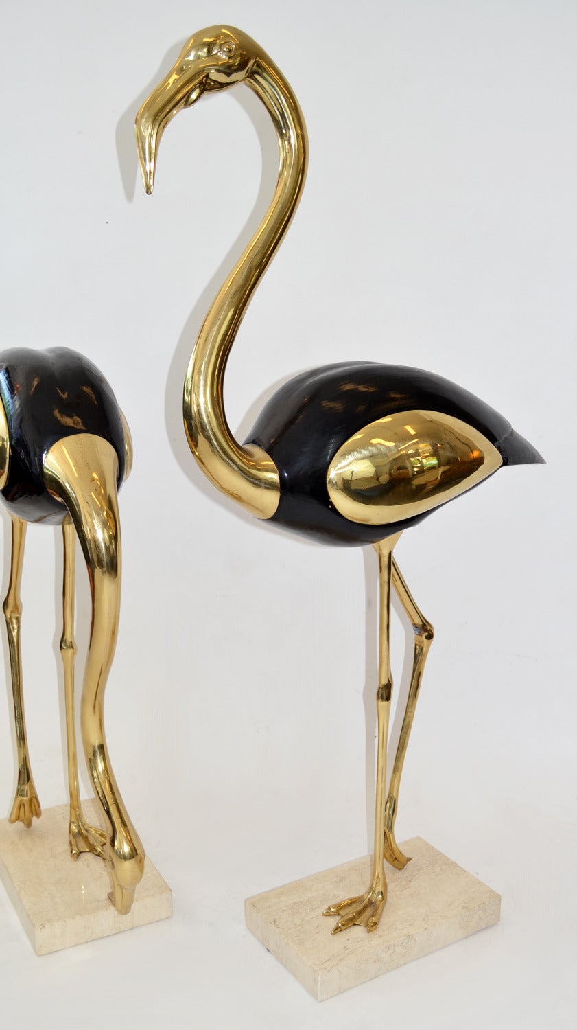 Pair of nearly five-foot tall stylized brass and ebonized wood Flamingos on travertine bases. Likely Italian.