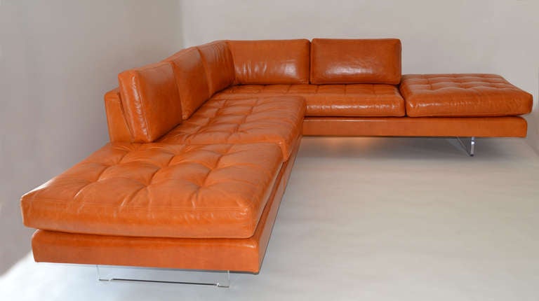 A fantastic example of the Omnibus series of furniture designed by Vladimir Kagan. This extremely comfortable sofa offers three sections upholstered in beautiful tufted baseball-glove leather with a loose cushion design. The right angle section is a