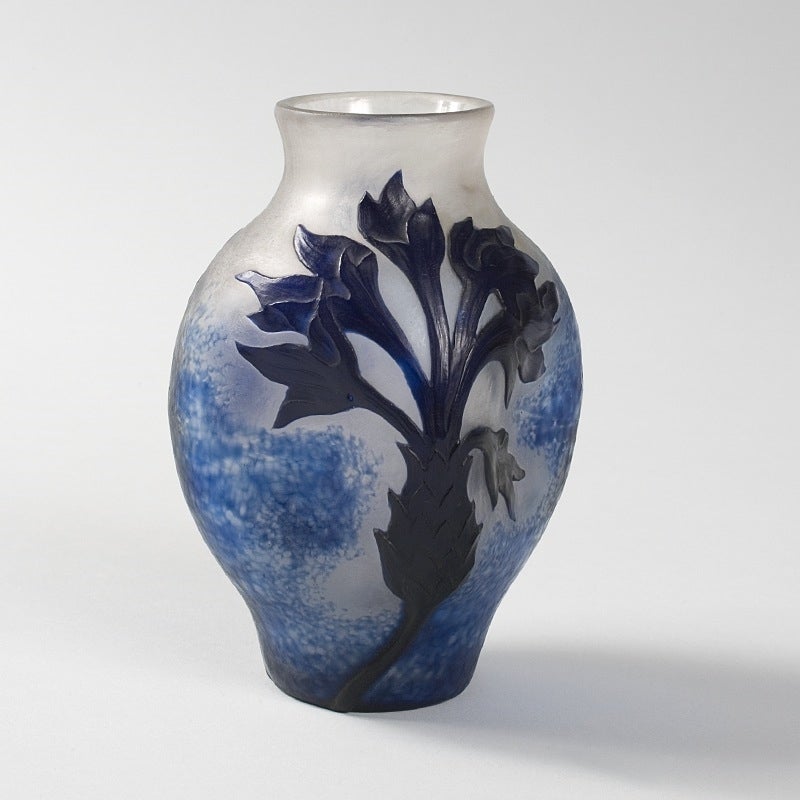 A French Art Nouveau wheel-carved cameo glass “Blooming Flower” vase by Daum, featuring a blooming flower in a deep blue, on an opaque white and mottled blue ground, circa 1900. 

A vase decorated in a similar style is pictured in: Daum: