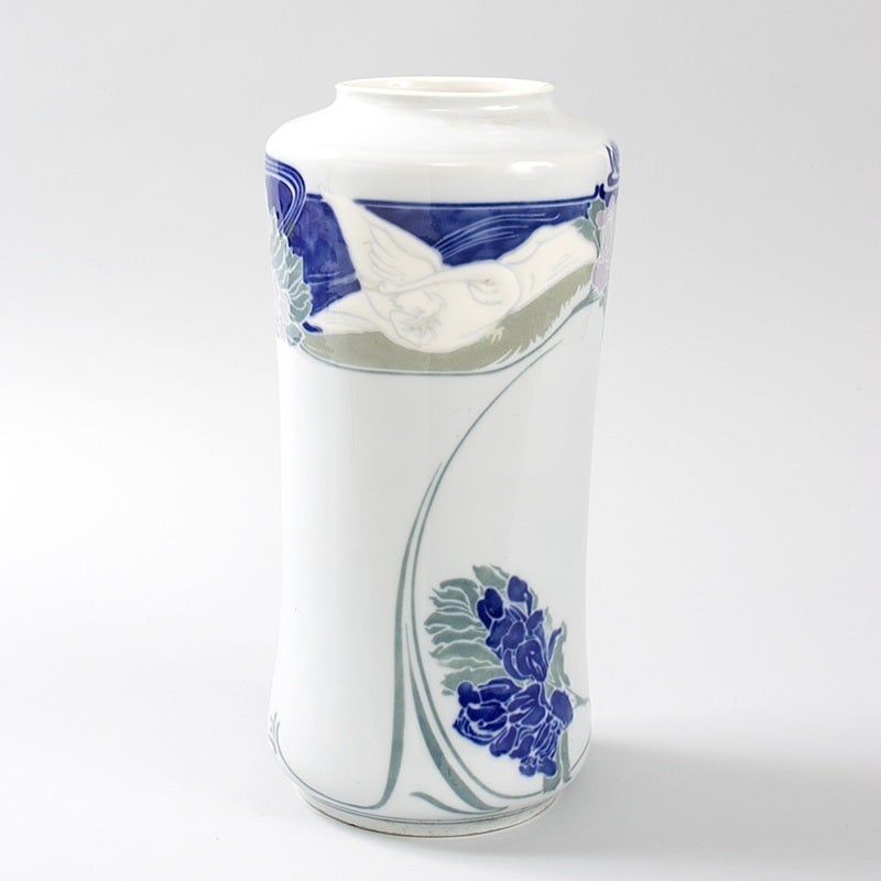 A French Art Nouveau porcelain vase by Georges De Feure, featuring a bird in the top area and flower and vine decorations throughout. This model was featured at Siegfried Bing’s Paris gallery, L’Art Nouveau - La Maison Bing, circa 1900. Signed, “ANB
