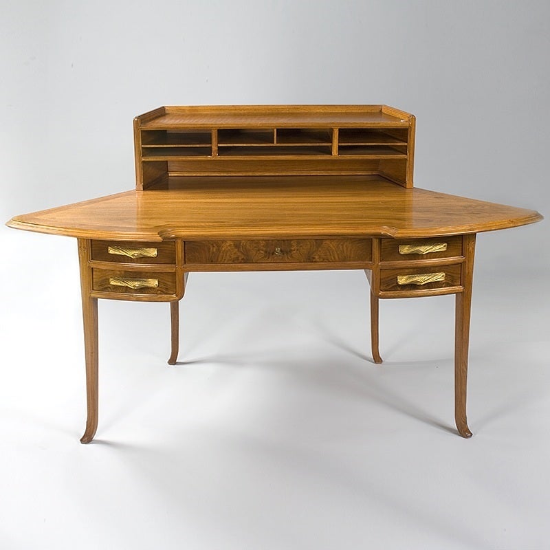 A French Art Nouveau walnut desk by Maurice Dufrène in pear wood with bronze handles in a seashell motif, circa 1900.

(MG #695)