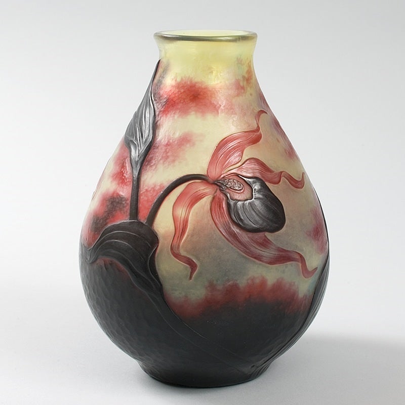A French Art Nouveau cameo glass vase by Daum, featuring red flowers and vines against a yellow and red martelé ground, circa 1910.

Signed, “Daum Nancy” with the Croix de Lorraine. 

A similar vase is pictured in: Daum Nancy: Maîtres