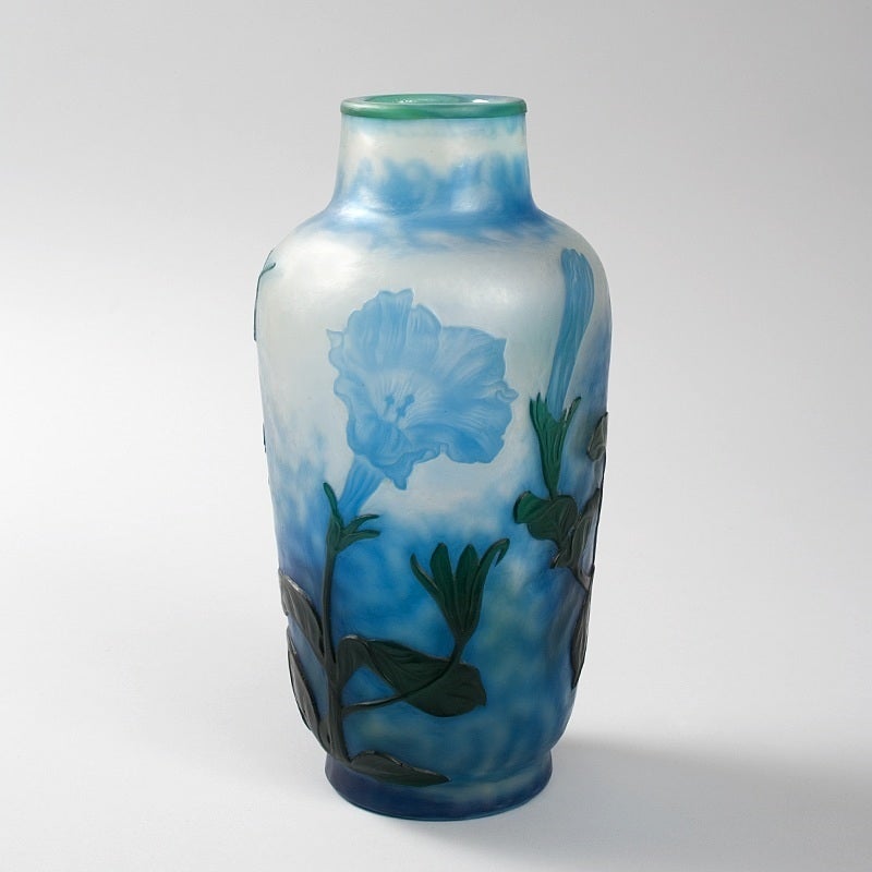 A French Art Nouveau wheel-carved cameo glass vase by Daum, featuring blue flowers and dark green stems and leaves against a mottled white and blue ground. Circa 1900.

A vase decorated in a similar style is pictured in: Daum: Collection du muse