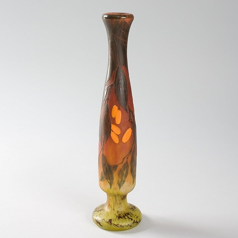 A French Art Nouveau wheel-carved cameo glass vase by Daum, featuring green leaves and orange berries against a dark orange and mottled light green ground, circa 1900. 

Signed, “Daum Nancy” with the Croix de Lorraine.

A vase with similar