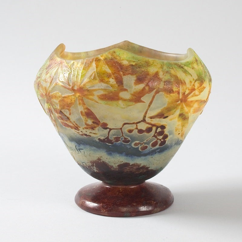 A French Art Nouveau cameo glass vase by Daum, featuring berries on branches in hues of browns, reds and greens, against a mottled white and blue ground, circa 1900.

A vase with similar decoration is pictured in: Daum Frères: Maîtres Verriers,