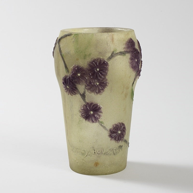 A French Art Nouveau pâte de verre vase by Gabriel Argy-Rousseau. The vase features purple flowers with green stems and leaves against an opalescent ground with hints or green, orange and purple, circa 1920.

Signed, 