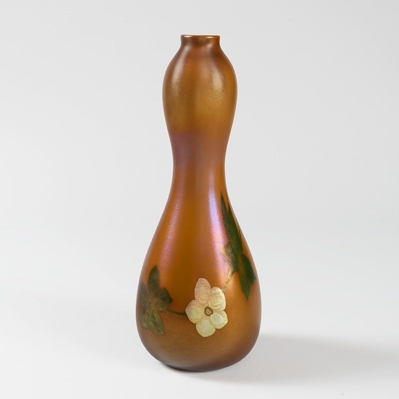 A favrile glass decorated vase by Tiffany Studios New York. 

This vase was featured in Ray and Lee Grover, Art Nouveau Glass, Rutland, Charles E. Tuttle Company Inc., 1970, p.88.

Also featured in Paul Doros, The Tiffany Collection of the
