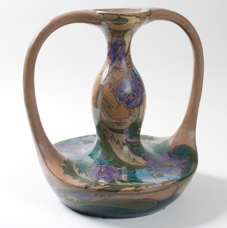 A Dutch Art Nouveau ceramic vase by Gouda-Zuid Holland, featuring two handles with a floral motif.
