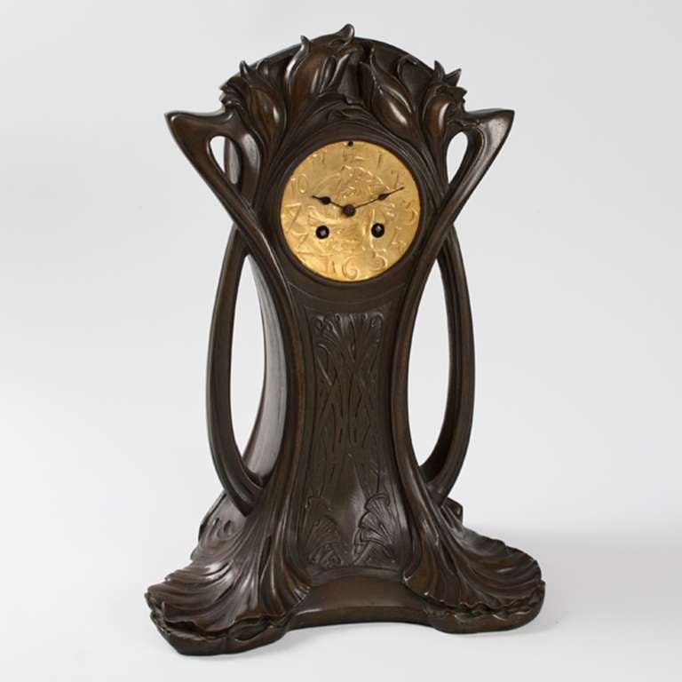 A French Art Nouveau patinated bronze and gilt metal mantel clock by P.H. Gautu, featuring curvilinear design and floral decoration. Pictured in: Dynamic Beauty: Sculpture of Art Nouveau Paris, by Macklowe Gallery, The Studley Press, 2011, p. 131.