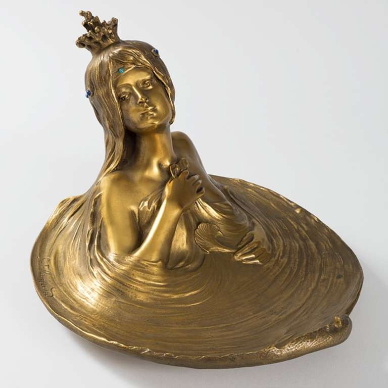 A French Art Nouveau gilt bronze figural encrier by Georges Flamand The whirlpool tray features a water sprite emerging from the water. In her hand she holds a ginko leaf and on her head she wears a crown and headdress decorated with turquoise