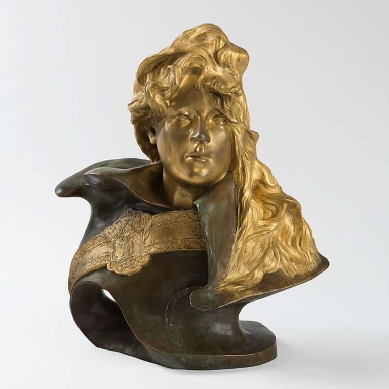 A French Art Nouveau gilt and patinated bronze portrait of Sarah Bernhardt by Paul François Berthoud. 

Sarah Bernhardt was the most important dramatic actress of the 19th Century. She is portrayed here with a jeweled sash and flowing hair, no