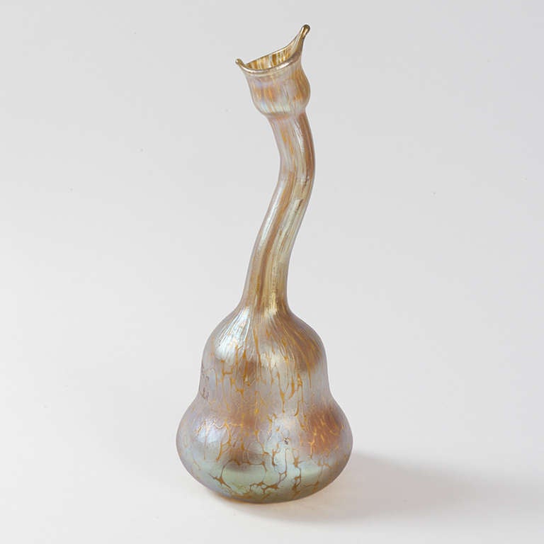 An Austrian Jugendstil gooseneck vase with iridescent decoration by Johann Loetz. The vase is decorated with silver striations over an opalescent gold background. The shape of this vase was inspired by Persian rose water sprinklers. Circa 1900. 

A